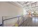 Second floor loft area with metal railings overlooking the staircase and colorful wall art at 5626 Deer Creek Falls Ct, Las Vegas, NV 89118