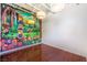 Bright room with cartoon wall art, hardwood floors, and exposed ceiling at 5626 Deer Creek Falls Ct, Las Vegas, NV 89118
