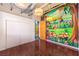 Bright room with cartoon wall art, hardwood floors, and closet at 5626 Deer Creek Falls Ct, Las Vegas, NV 89118