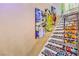Staircase with colorful pop art murals on the walls and printed designs on the stair treads at 5626 Deer Creek Falls Ct, Las Vegas, NV 89118
