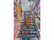 Staircase with graffiti-style artwork creates a bold, artistic feature, ascending to the upper level at 5626 Deer Creek Falls Ct, Las Vegas, NV 89118