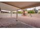 Backyard featuring covered patio, stone landscaping, and secure privacy fence at 6436 Point Break St, North Las Vegas, NV 89084