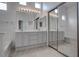Elegant bathroom with a double vanity, a bathtub, and a glass-enclosed shower at 6436 Point Break St, North Las Vegas, NV 89084