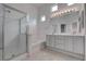 Bright bathroom featuring a glass enclosed shower, soaking tub and double sink vanity at 6436 Point Break St, North Las Vegas, NV 89084