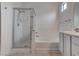 Bathroom featuring a glass-enclosed shower, soaking tub, and sleek vanity at 6436 Point Break St, North Las Vegas, NV 89084