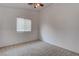 Neutral bedroom features a window with blinds, carpeted flooring, and neutral walls at 6436 Point Break St, North Las Vegas, NV 89084