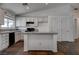 Modern kitchen with white cabinetry, granite countertops, and a stylish breakfast bar, ideal for entertaining at 6436 Point Break St, North Las Vegas, NV 89084