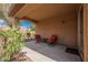 Relaxing backyard patio with two cushioned chairs, ideal for enjoying outdoor leisure and a small table at 6737 Divers Loons St, North Las Vegas, NV 89084