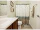 Well-lit bathroom featuring a shower with dragonfly curtain, vanity, and neutral color scheme at 6737 Divers Loons St, North Las Vegas, NV 89084