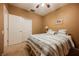 A cozy bedroom features a ceiling fan, closet, carpet, and a comfortable bed, with neutral walls at 6737 Divers Loons St, North Las Vegas, NV 89084