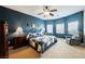 Comfortable bedroom with ample natural light, a ceiling fan, and blue accent wall at 6737 Divers Loons St, North Las Vegas, NV 89084