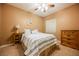 Cozy bedroom with a ceiling fan, carpet floors, and a comfortable bed set against a neutral wall at 6737 Divers Loons St, North Las Vegas, NV 89084