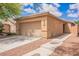 Exterior view of the home, including the driveway, two car garage and rock landscaping at 6737 Divers Loons St, North Las Vegas, NV 89084