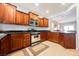 Cozy kitchen boasting granite countertops, stainless steel appliances and rich wood cabinetry at 6737 Divers Loons St, North Las Vegas, NV 89084