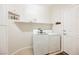 Bright laundry room with a modern washer and dryer set, complemented by a 'Welcome' sign and neat shelving at 6737 Divers Loons St, North Las Vegas, NV 89084