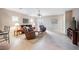 Open living room featuring neutral tile flooring, ceiling fan, and sliding glass door at 6737 Divers Loons St, North Las Vegas, NV 89084