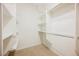 Organized walk-in closet with shelving and hanging rods for efficient storage at 6737 Divers Loons St, North Las Vegas, NV 89084