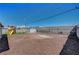 Fenced backyard featuring a playset, small storage shed, and gravel at 7 Church St, Henderson, NV 89015