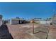 Fenced backyard featuring a playset, small storage shed, and gravel at 7 Church St, Henderson, NV 89015