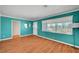 Inviting living room features laminate floors, turquoise walls and plenty of natural light at 7 Church St, Henderson, NV 89015