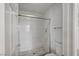 Updated bathroom featuring a white tiled shower with a glass enclosure and modern fixtures at 7888 Bonaventure Dr, Las Vegas, NV 89147