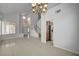 Spacious living area with tile floors, staircase, and views into the dining area and kitchen at 7888 Bonaventure Dr, Las Vegas, NV 89147