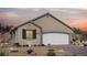 Charming single-story home featuring desert landscaping, a two-car garage, and a neutral color palette at 85 Serene Tempo Ave, Henderson, NV 89011