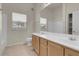 Bathroom featuring a dual sink vanity with wooden cabinets and a large mirror above at 8805 Jeffreys St # 2020, Las Vegas, NV 89123
