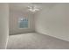 A cozy bedroom with neutral walls, plush carpet, and ceiling fan at 8805 Jeffreys St # 2020, Las Vegas, NV 89123