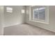 Bright bedroom with neutral walls and plush carpeting, highlighted by natural light from two windows at 8805 Jeffreys St # 2020, Las Vegas, NV 89123