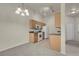 Modern kitchen with wooden cabinets, white appliances, and track lighting at 8805 Jeffreys St # 2020, Las Vegas, NV 89123