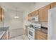 Bright eat-in kitchen features wooden cabinets, modern appliances and tile flooring at 8805 Jeffreys St # 2020, Las Vegas, NV 89123