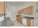 Well-lit kitchen features wooden cabinets, granite countertops, and modern appliances at 8805 Jeffreys St # 2020, Las Vegas, NV 89123