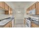 Well-lit kitchen with wood cabinets, stainless steel appliances, and neutral countertops at 8805 Jeffreys St # 2020, Las Vegas, NV 89123