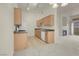 Open kitchen area with wooden cabinets and modern stainless steel appliances at 8805 Jeffreys St # 2020, Las Vegas, NV 89123