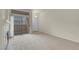 Bright living room boasts patio access, neutral paint and plush carpeting at 8805 Jeffreys St # 2020, Las Vegas, NV 89123