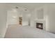 Bright living room features a cozy fireplace, neutral carpet, and an open layout at 8805 Jeffreys St # 2020, Las Vegas, NV 89123