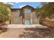 Home's backyard featuring a large concrete patio, a low-maintenance desert landscape, and a view of the home's rear exterior at 9115 Weeping Hollow Ave, Las Vegas, NV 89178