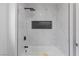 Modern bathroom featuring a shower and tub combination with a shower head and tiled walls at 9115 Weeping Hollow Ave, Las Vegas, NV 89178