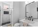 Modern bathroom with glass-enclosed shower featuring black honeycomb tile accents and contemporary fixtures at 9115 Weeping Hollow Ave, Las Vegas, NV 89178