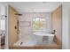 Contemporary bathroom features a soaking tub, walk-in shower, and sleek fixtures with a modern tile accent wall at 9115 Weeping Hollow Ave, Las Vegas, NV 89178