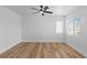 Bedroom with neutral walls, wood-look floors, and a ceiling fan, providing a cozy atmosphere at 9115 Weeping Hollow Ave, Las Vegas, NV 89178