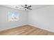 Bright bedroom with wood-look floors, a ceiling fan, and a window letting in natural light at 9115 Weeping Hollow Ave, Las Vegas, NV 89178