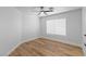 Bedroom featuring neutral walls, wood-look floors, a ceiling fan, and a window at 9115 Weeping Hollow Ave, Las Vegas, NV 89178