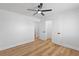 Bedroom featuring wood-look floors, a ceiling fan, and doors leading to other rooms at 9115 Weeping Hollow Ave, Las Vegas, NV 89178