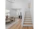 Inviting entryway with staircase, wood-look flooring, and dining area at 9115 Weeping Hollow Ave, Las Vegas, NV 89178