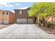 Two story home with a long driveway and attached three car garage at 9115 Weeping Hollow Ave, Las Vegas, NV 89178