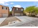 Exterior shot of a two-story home boasting a three car garage and front yard landscaping at 9115 Weeping Hollow Ave, Las Vegas, NV 89178