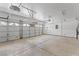 Spacious two-car garage featuring a clean epoxy floor and automatic door openers, perfect for vehicle storage and workshop space at 9115 Weeping Hollow Ave, Las Vegas, NV 89178