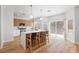 Open kitchen with stainless appliances, center island with breakfast bar and seating, and sliding glass doors to patio at 9115 Weeping Hollow Ave, Las Vegas, NV 89178